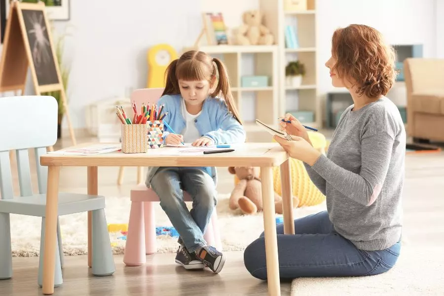 Arteterapeuta prowadzący terapię przez sztukę z dzieckiem